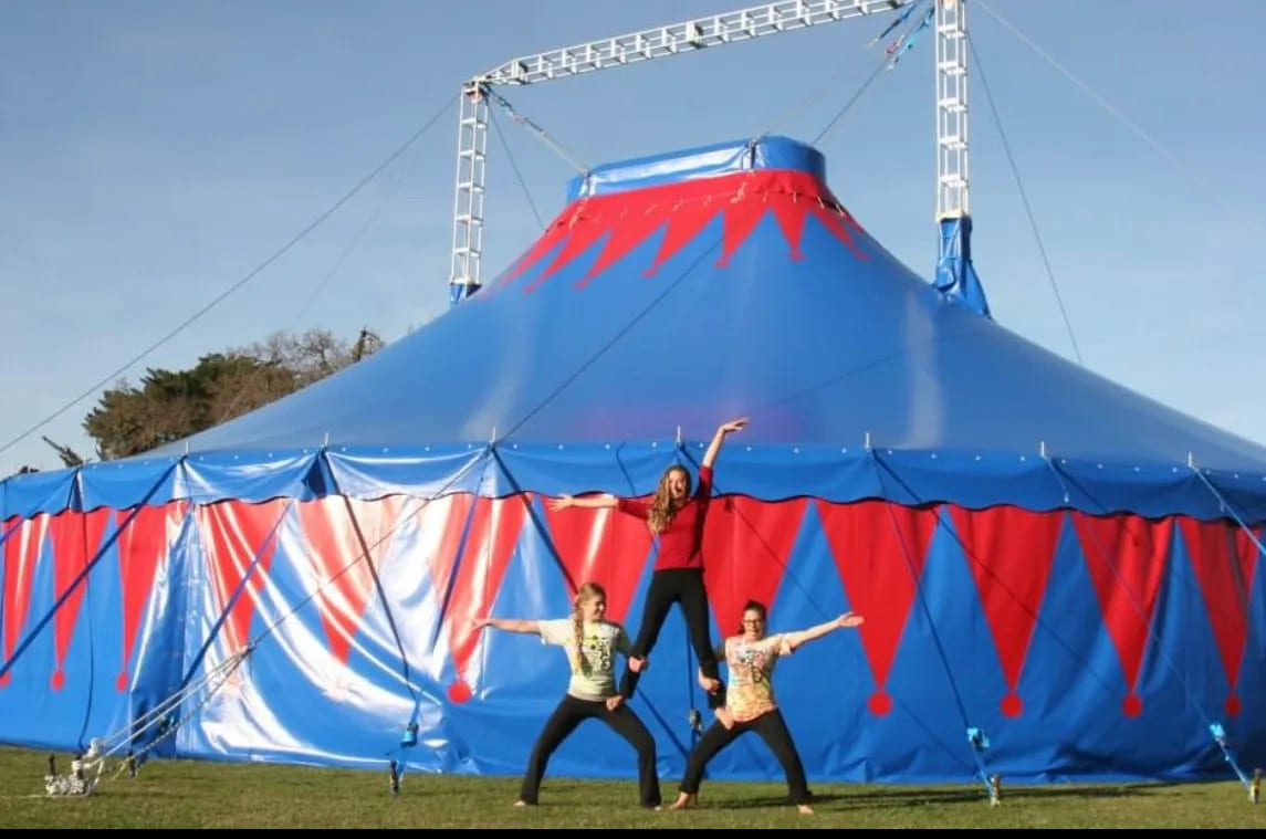 Circus students hold a balance in front of the Big Top.