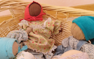 waldorf dolls in a basket